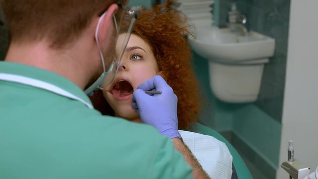 Smiling woman visiting dentist. Slow motion. Close up