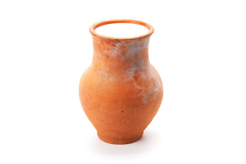 clay pitcher filled with milk
