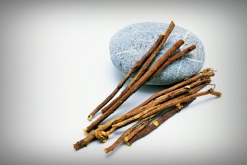 Liquorice root lying on a white background