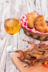 roast quail and a glass of white wine