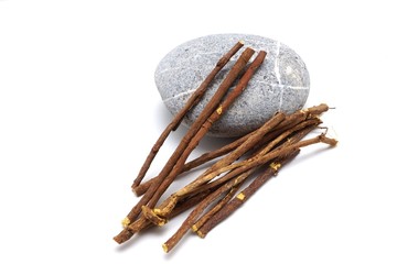 Liquorice root lying on a white background