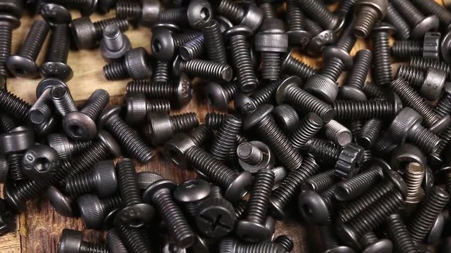 A pile of computer metallic screws. Macro shot.