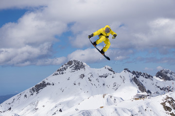 Snowboarder jumping on mountains. Extreme sport.