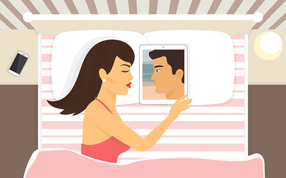 Young woman sleeping with tablet pc and dreaming of her boyfriend which photo placed on the display