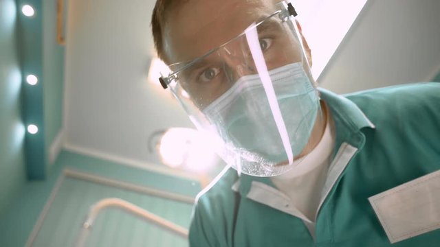 Dentist treating pretty patient. Slow motion. Close up