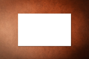 Fototapeta premium white blank name card on leather background