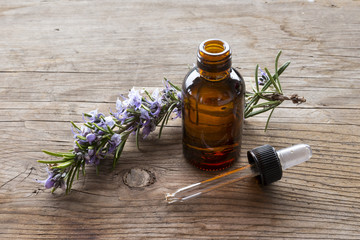 close-up of essence of rosemary on wooden table