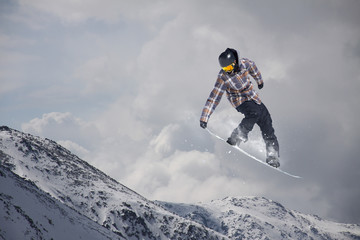 Snowboarder jumping on mountains. Extreme sport.