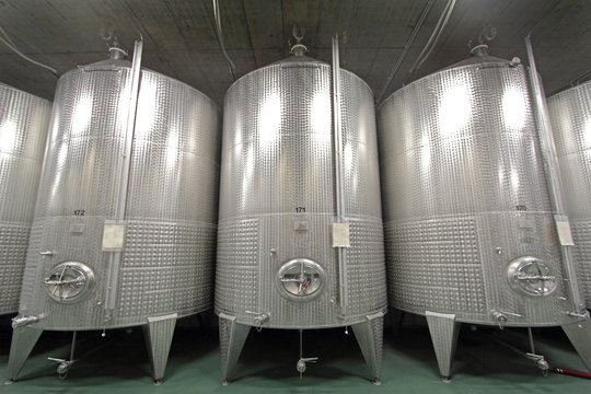 Stainless steel vats on industrial wine cellar