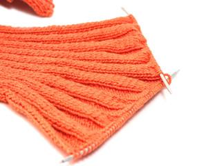 Knitting with metal knitting of cotton thread orange color Italian on a white background