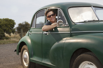 Portrait of young man in vintage morris minor