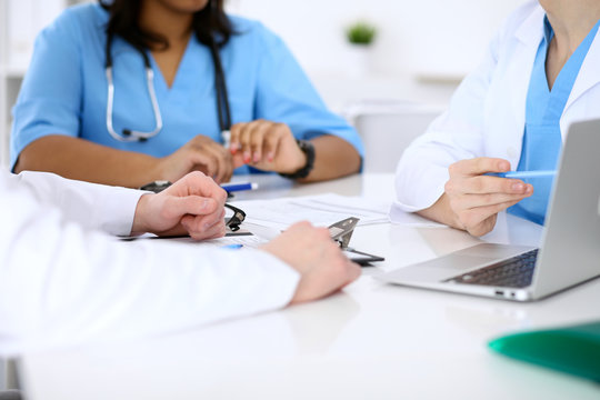 Group of doctors discuss at meeting