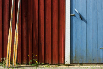Oars against a red cottage