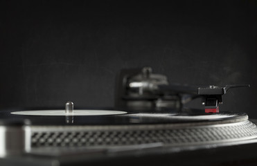 Turntable playing vinyl close up with needle on the record