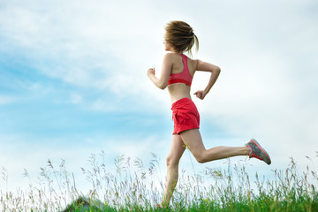 Young woman running summer park rural road. Outdoor exercises. J