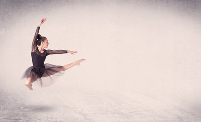 Fototapeta premium Modern ballet dancer performing art jump with empty background