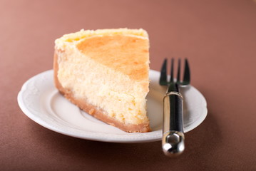 piece of cheesecake on the plate on the table