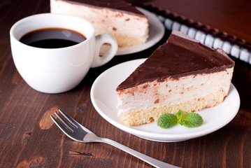 piece of cake with chocolate icing and coffee
