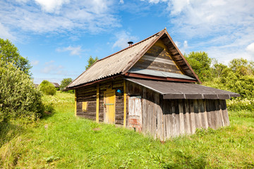 Traditional russian wooden bath at the countryside in summer sun