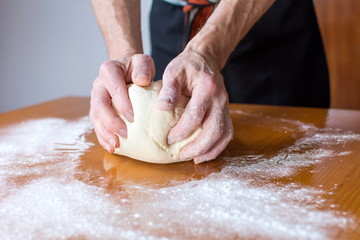 Baker makes bread on the table