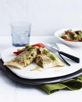 Plate with garnished tuna and egg briks and side dish