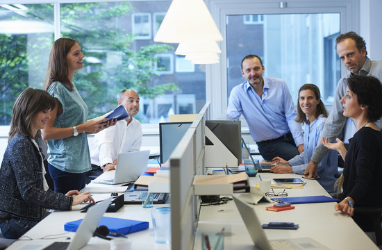 Businesspeople meeting around desk