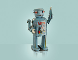 Studio shot of blue robot with arm raised