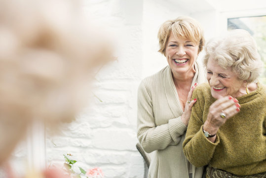 Senior woman with daughter, laughing