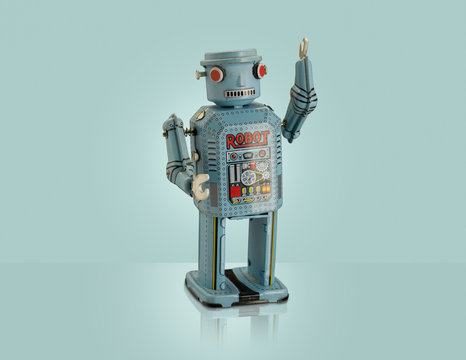Studio shot of blue robot with arm raised