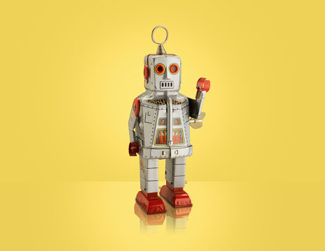 Studio shot of silver robot with arm raised