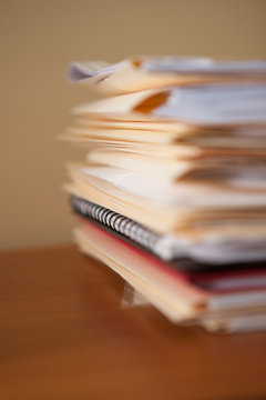 Close up of stack of paperwork and files on office desk