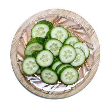 Fresh sliced cucumber on board isolated