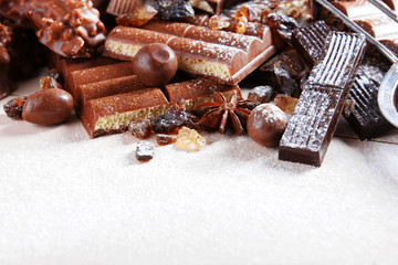 Chocolate sweets with powder on wooden background