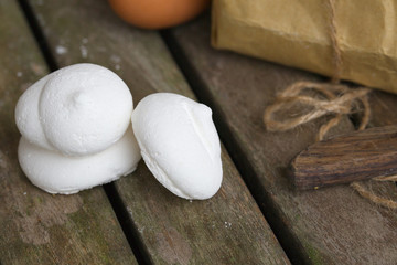 Italian meringue on an old wooden surface.