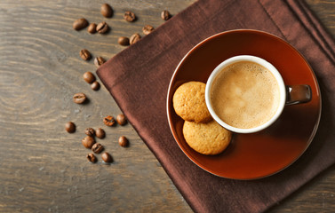 Cup of coffee on wooden table background