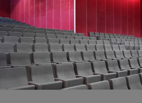 Grey chairs in empty auditorium