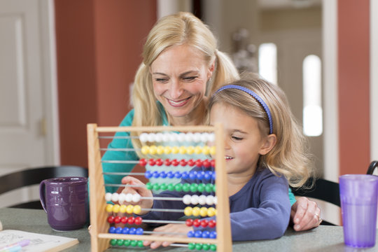 Mother and young daughter with abacus