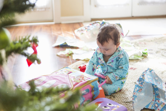 Baby girl opening christmas presents