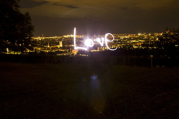 Love, light painting at night with view of Vienna, Austria
