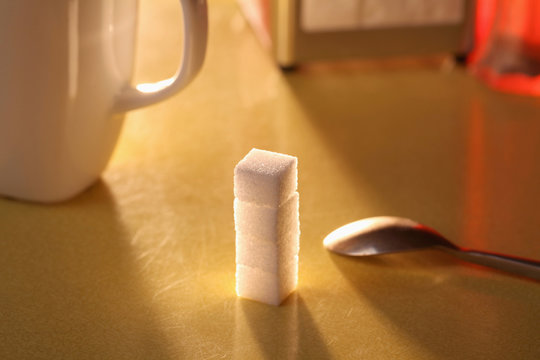 Sugar lumps stacked on table
