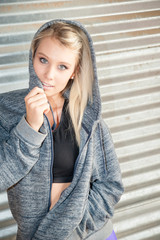 Sporty female wearing a hooded sweatshirt