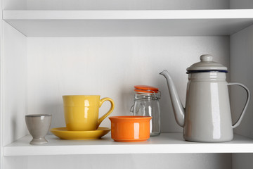 Tableware on shelf in the kitchen cupboard