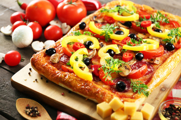 Rectangle delicious pizza and vegetables on the table