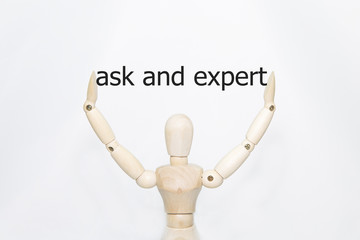 Hand writing ask and expert with wooden persona on transparent wipe board.