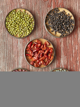 Five dishes containing dried food: Mung Beans, Black Barley, Pequin Chiles, Adzuki Beans, French Green Lentils