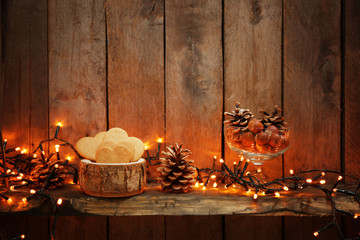 Cookies with pine cones and hazelnuts on wooden background
