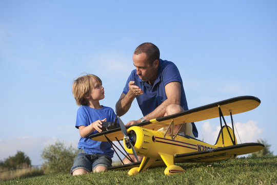 Father and son preparing model plane