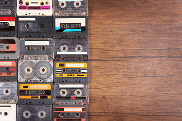 Obraz premium Collection of audio cassettes on wooden table background, copy space