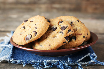 Chocolate chip cookies on jeans napkin on wooden table