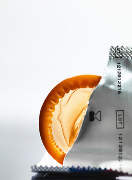 Torn packaging of wrapper containing a condom